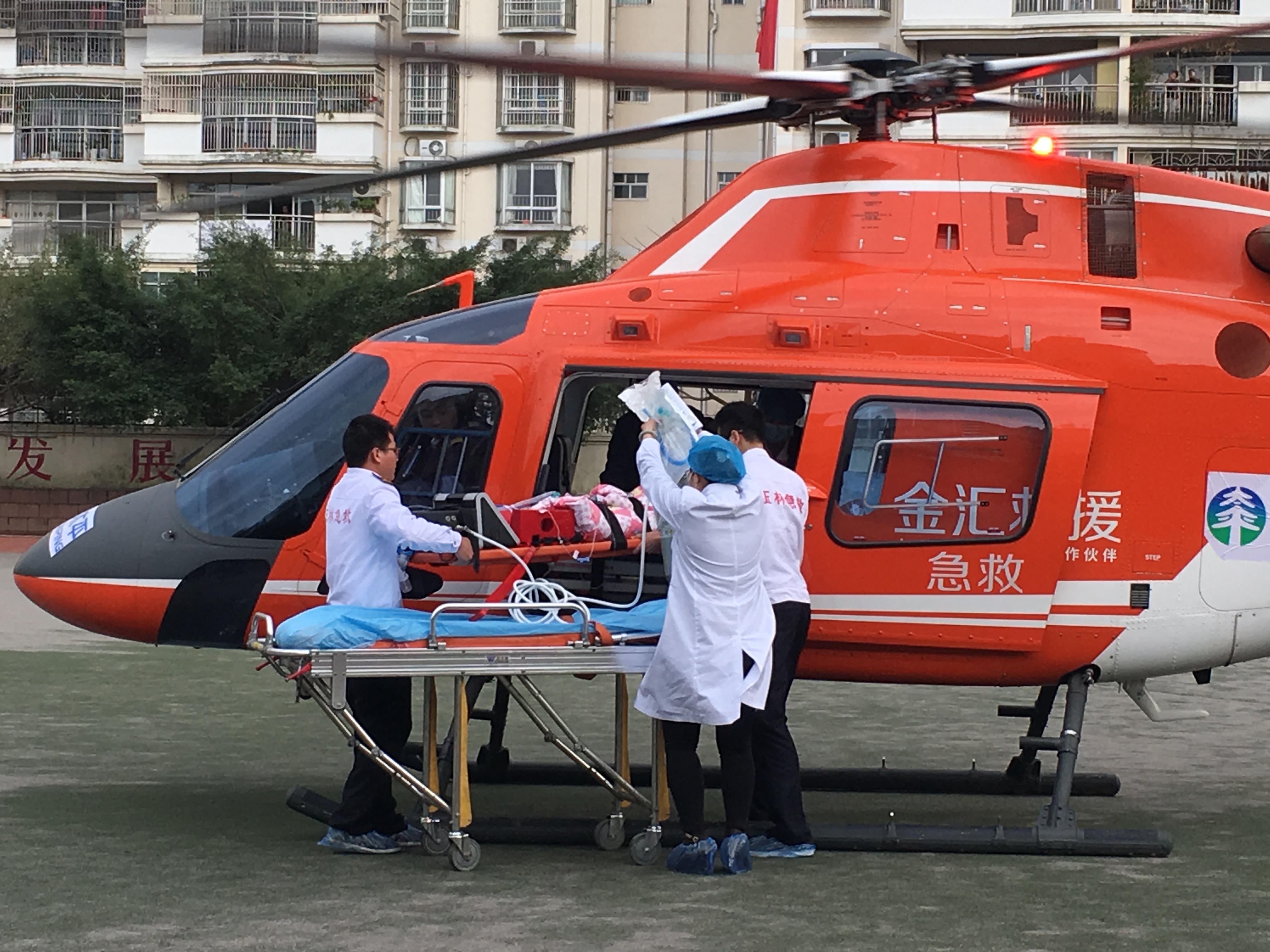 配图1：在玉林市，患儿被平稳地抬上直升机.jpg